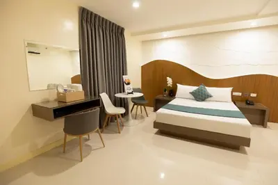 a hotel room with a bed and a desk at Hotel Dreamworld East Ortigas in Manila