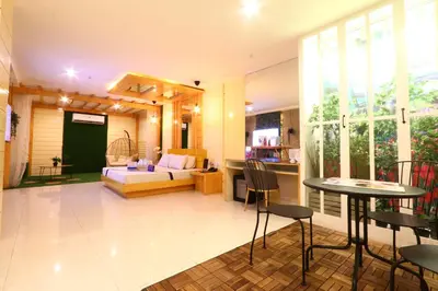a living room with a couch and a table at Hotel Dreamworld East Ortigas in Manila