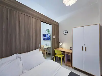 a bedroom with a bed and a desk and a table at 1BR Condotel with Balcony at FAME Residences #FM31 in Manila
