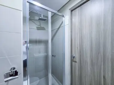 a shower with a glass door in a bathroom at 1BR Condotel with Balcony at FAME Residences #FM31 in Manila