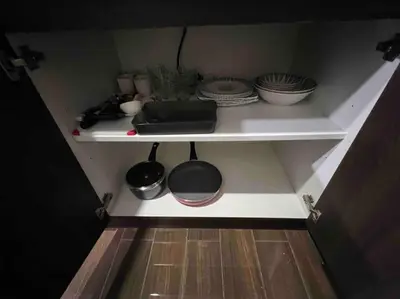 a kitchen shelf with dishes and plates on it at AIR Residences - 1 Bedroom Unit with Wifi and Netflix in Manila