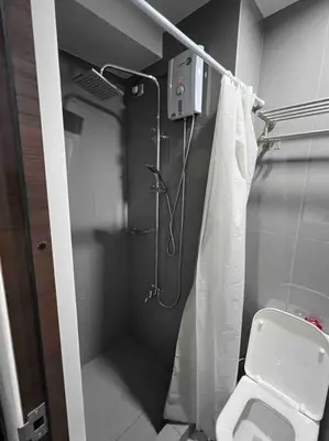 a bathroom with a shower and a toilet in it at AIR Residences - 1 Bedroom Unit with Wifi and Netflix in Manila