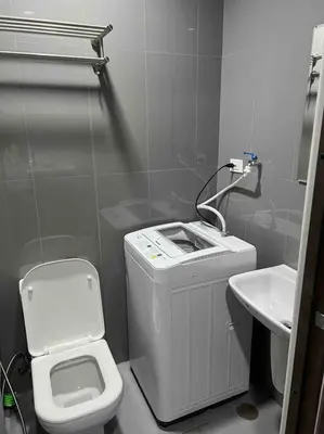 a small bathroom with a toilet and a sink at AIR Residences - 1 Bedroom Unit with Wifi and Netflix in Manila