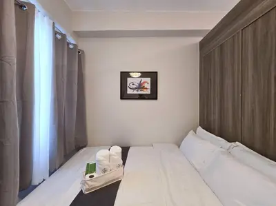 a hotel room with a bed and a window at 1BR Condotel with Balcony at FAME Residences #FM32 in Manila