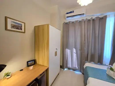 a room with a bed and a desk and a window at 1BR Condotel with Balcony at FAME Residences #FM33 in Manila