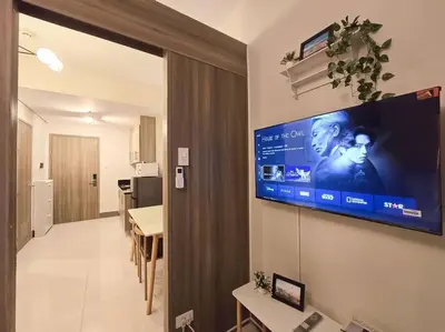 a room with a flat screen tv on a wall at 1BR Condotel with Balcony at FAME Residences #FM34 in Manila
