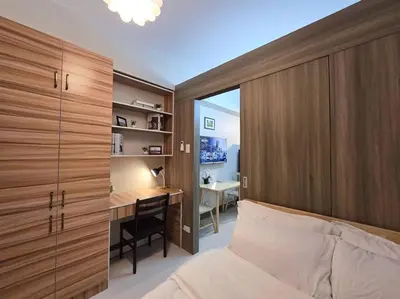 a bedroom with a bed and a desk and a table at 1BR Condotel with Balcony at FAME Residences #FM38 in Manila