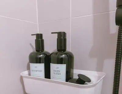 two bottles of wine in a holder in a bathroom at Bright & Airy Studio near Venice Mall with Pool, Gym & Fast WiFi in Manila