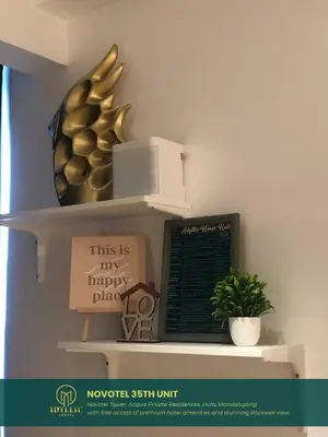 a shelf with a sign and a plant on it at Novotel Tower at Mandaluyong Rockwell View in Manila