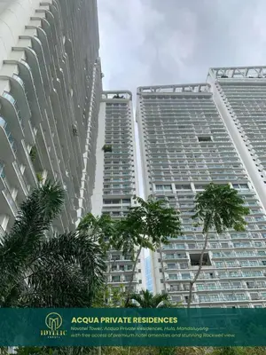 two tall buildings with palm trees in front of them at Novotel Tower at Mandaluyong Rockwell View in Manila