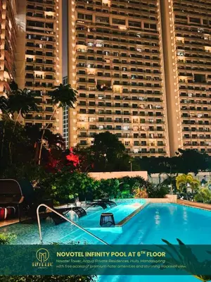 a large swimming pool in front of a large building at Novotel Tower at Mandaluyong Rockwell View in Manila