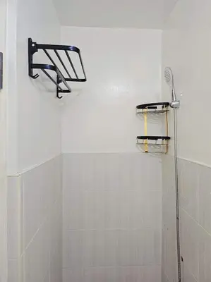 a bathroom with a shower and a shower head at Bubu and son suites staycation beside enchanted kingdom in Santa Rosa