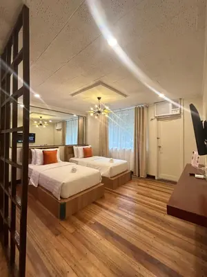 a large bedroom with two beds and a couch at Makati Medical City Accommodation in Manila