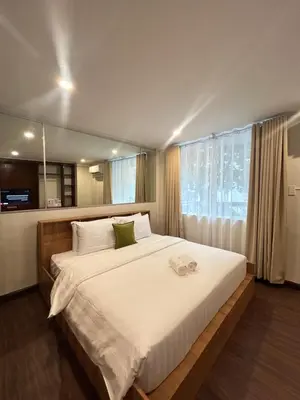 a bedroom with a large bed with a large window at Makati Medical City Accommodation in Manila