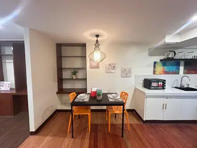 a kitchen and dining room with a table and chairs at Makati Medical City Accommodation in Manila