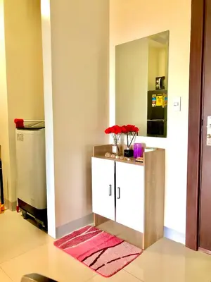 a room with a counter with a mirror and a sink at Uptown Parksuites BGC with Balcony in Manila