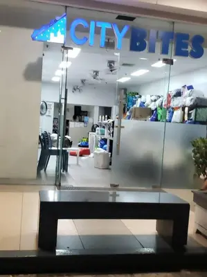 a city blue store with a bench in front of it at JoVis Place Staycation near MOA(Wifi & Netflix) in Manila