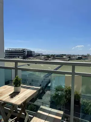 a balcony with a wooden table on top of a building at Azure Urban Resort Residences in Manila