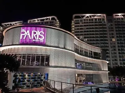 a large building with a sign on it at night at Azure Urban Resort Residences in Manila
