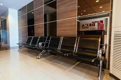 a row of empty seats in a mall with a sign at Urban Deca Tower OYO 2 in Manila