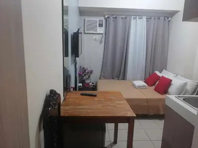 a small room with a bed and a table at Urban Deca Tower OYO 2 in Manila