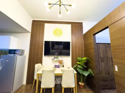 a kitchen with a table and chairs and a refrigerator at 1BR Makati, Air Residences M002 in Manila