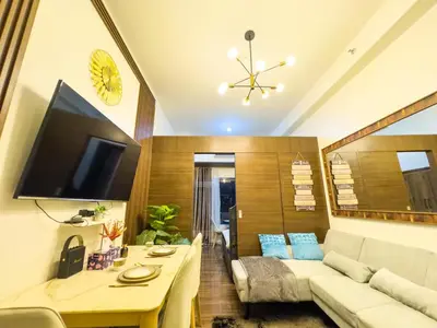 a living room with a couch and a table at 1BR Makati, Air Residences M002 in Manila