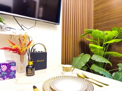 a table with a plate and a bottle of wine at 1BR Makati, Air Residences M002 in Manila
