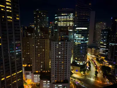 a view of a city at night with many tall buildings at 1BR Makati, Air Residences M002 in Manila