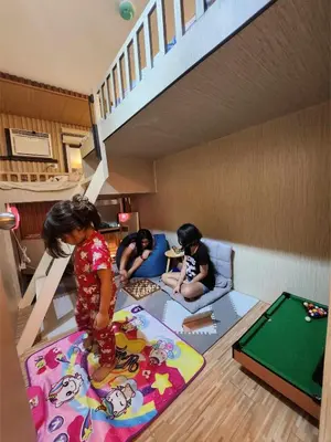 a group of children playing in a room with a rug at Dlighful Pad's MassageChair FreeParking Bar Park Garden in Manila