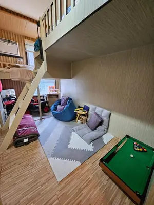 a living room with a pool table and a staircase at Dlighful Pad's MassageChair FreeParking Bar Park Garden in Manila