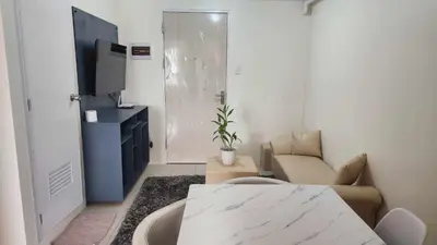 a living room with a couch and a tv at URBAN DECA R1125 Ortigas SM EAST in Manila
