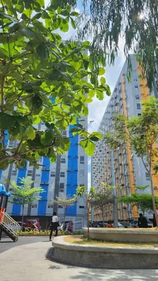 a person riding a skateboard in front of a tall building at URBAN DECA R1125 Ortigas SM EAST in Manila