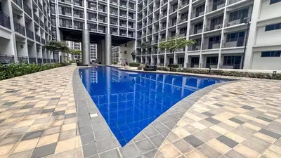 a swimming pool in the middle of a building at Oasis Urban Stay 2 in Manila