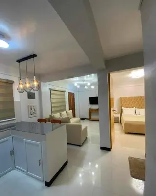 a large living room with a kitchen and a living room at House Tahhánne in Amadeo