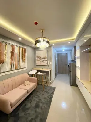 a living room with a couch and a table at The SK home at the shore in Manila
