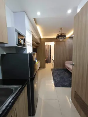 a kitchen with a sink and a microwave at The SK home at the shore in Manila