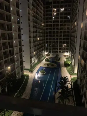 a swimming pool in the middle of a building at night at The SK home at the shore in Manila