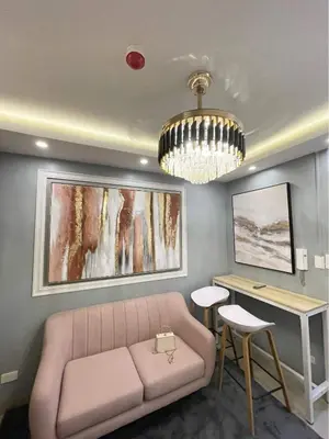 a living room with a couch and a table at The SK home at the shore in Manila