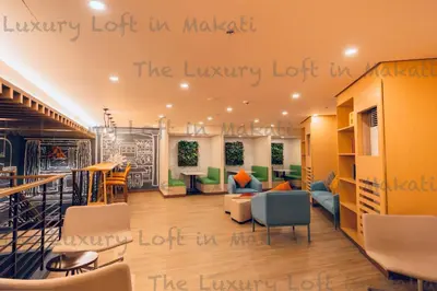 a lobby with a library with alibrary lot in maliki at Cozy Loft in Makati in Manila