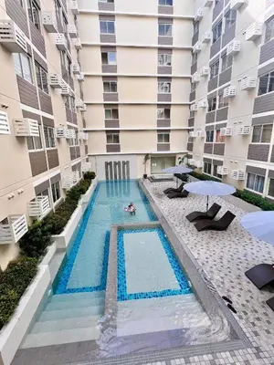 an overhead view of a swimming pool in front of a building at Condo in silang - near nuvali and tagaytay in Silang