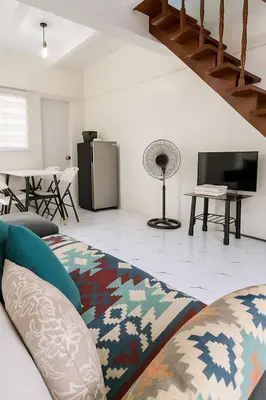a living room with a couch and a television at MiKasa Azul Transient House in Cabuyao
