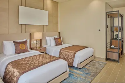 a hotel room with two beds and a television at Grand Westside Manila Bay in Manila