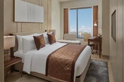 a hotel room with a large bed and a desk at Grand Westside Manila Bay in Manila