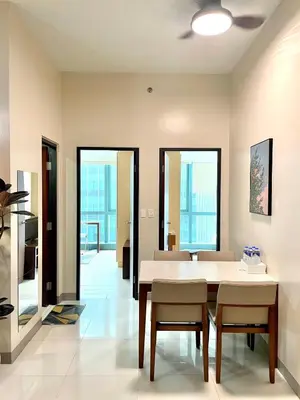 a dining room with a table and chairs at Spacious 2-BR unit in One Uptown Residences in Manila