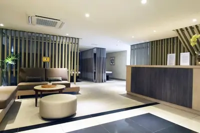 a lobby with a couch and a table in a room at Executive Stay with Balcony & Malls at Uptown BGC in Manila