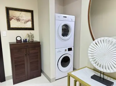 a laundry room with a washer and a washing machine at Executive Gem beside Malls and Bars at Uptown BGC in Manila