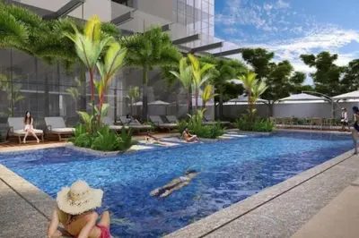 a rendering of a hotel pool with people swimming at Executive Gem beside Malls and Bars at Uptown BGC in Manila