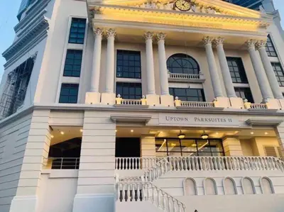 a building with a clock on top of it at Executive Gem beside Malls and Bars at Uptown BGC in Manila
