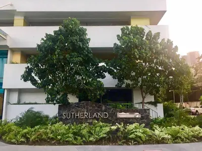 a sign in front of a building with trees at Skyloft Acqua Private Residences in Manila